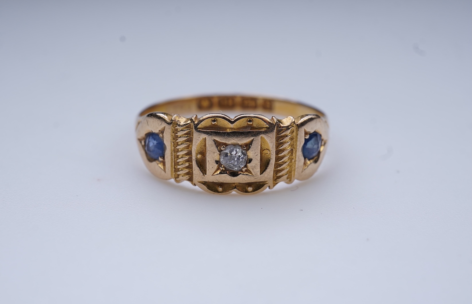 A Victorian sapphire and diamond three-stone ring, circa 1892